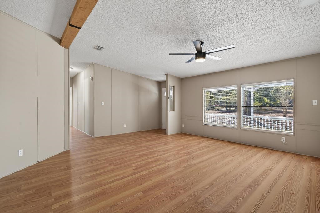 2744 Roy Sikes Road Hilliard, FL 32046 - Photo 12 of 97 a view of an empty room with a window and wooden floor