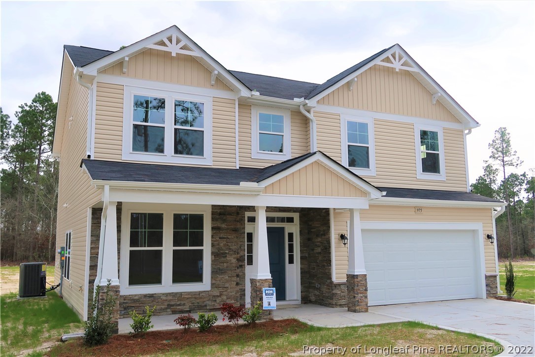 975 Montrose Road Raeford, NC 28376 - Photo 1 of 18 a front view of a house with a yard and garage