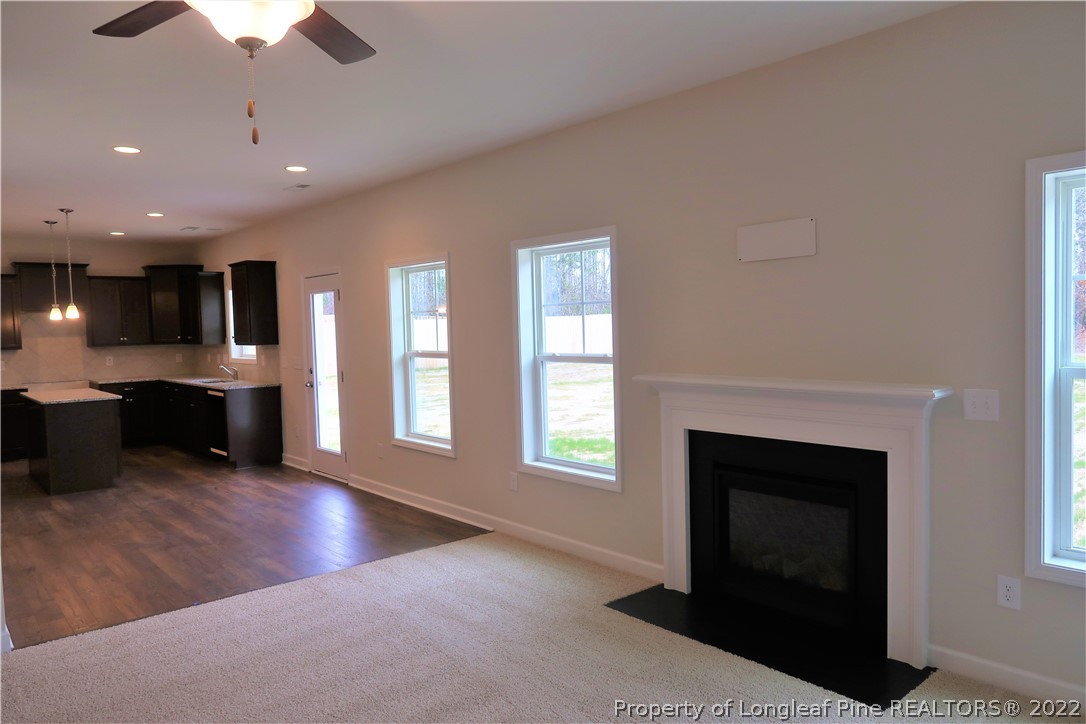 975 Montrose Road Raeford, NC 28376 - Photo 8 of 18 a view of kitchen with furniture fireplace and window