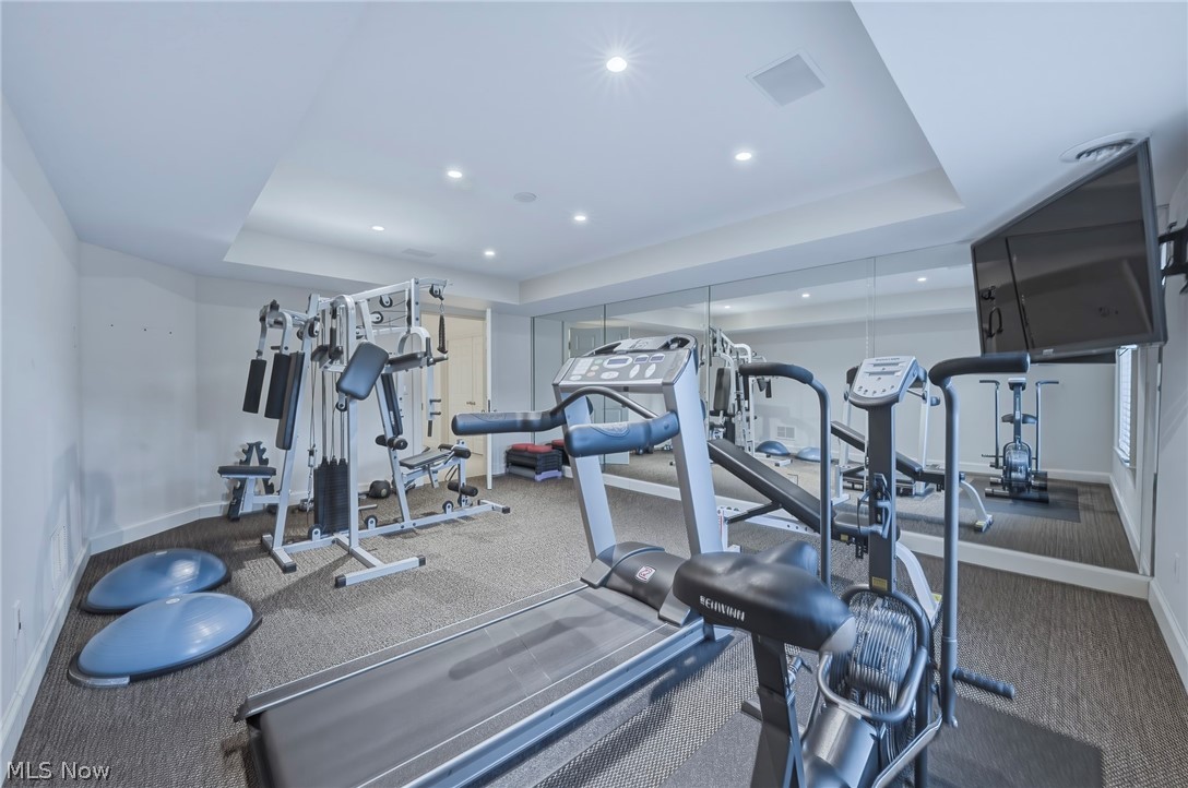 31900 Pinetree Road Pepper Pike, OH 44124 - Photo 38 of 43 One lower level room has been converted into an exercise room complete with a wall of mirrors and TV.