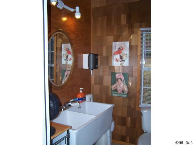 990 Childers Road Cleveland, NC 27013 - Photo 4 of 7 a bathroom with a sink mirror and vanity