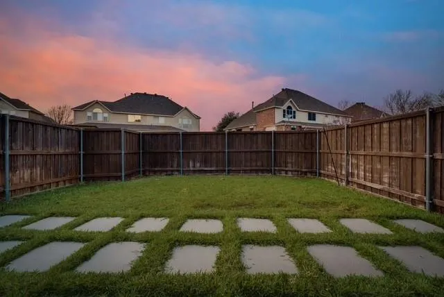 a view of a park with iron fence