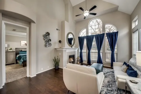 a living room with furniture chandelier and a large window