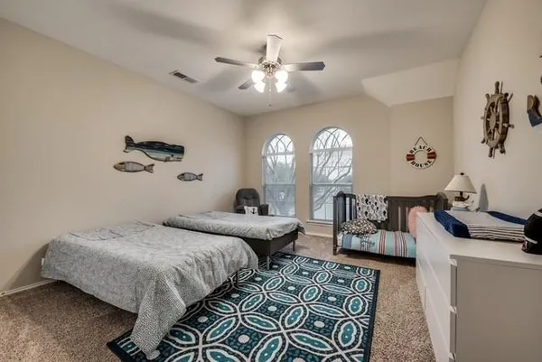 a bedroom with bed and a chandelier