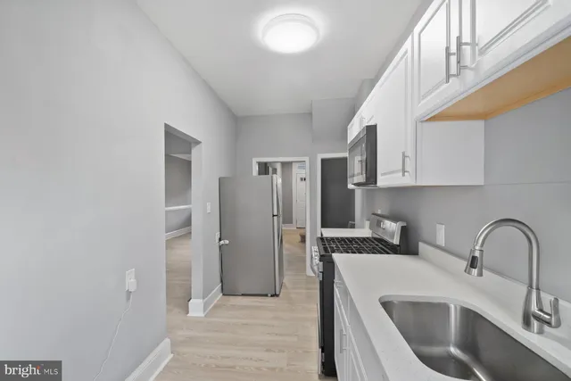 a kitchen with stainless steel appliances a refrigerator and a sink