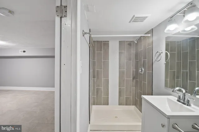 a bathroom with a shower and a sink