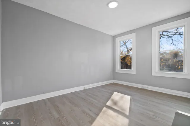 an empty room with windows and closet