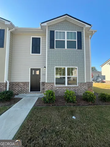 a front view of a house with garden