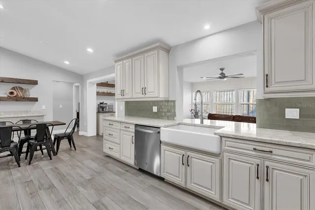 a kitchen with white cabinets and white appliances