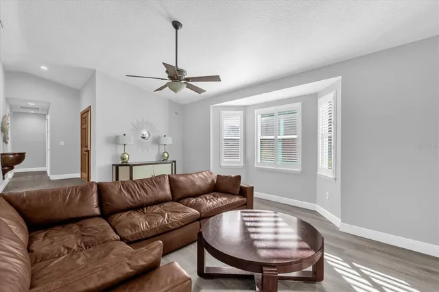 a living room with furniture a chandelier and a window