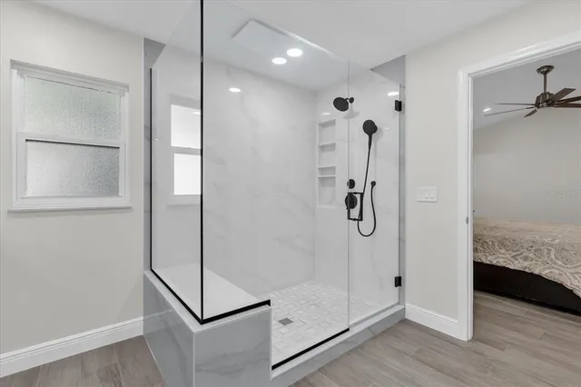 a bathroom with a shower and mirror