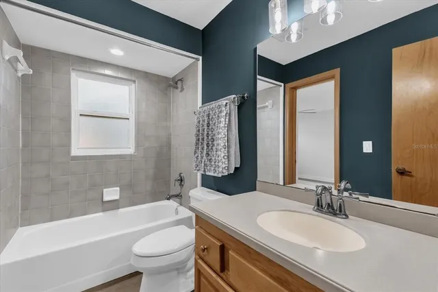 a bath room with a toilet a sink and a bath tub