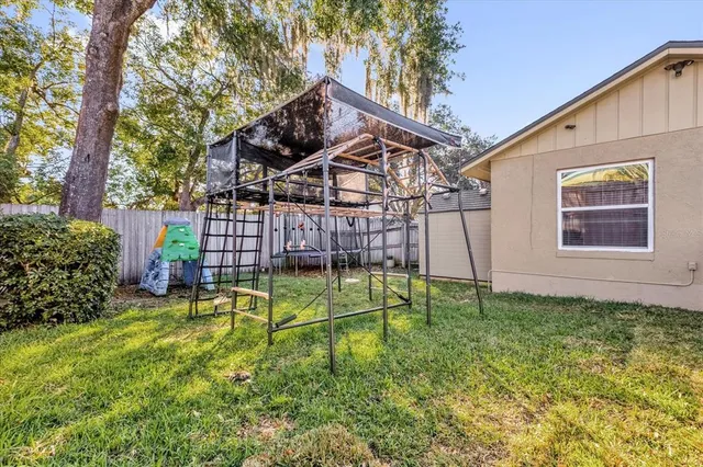 a view of a backyard with plants and a small pool