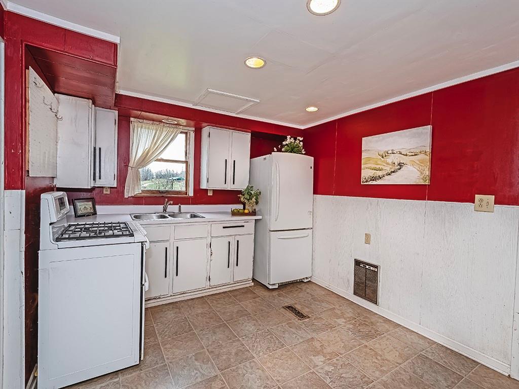 1283 Martin Road Apollo, PA 15613 - Photo 13 of 24 a kitchen that has a refrigerator a sink and a stove