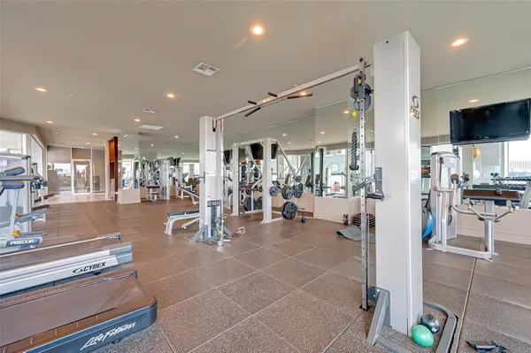 a view of a room with lots of gym equipment