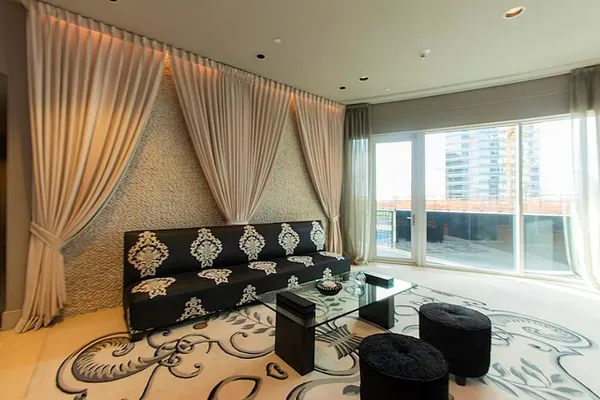 a room with pool table and sofas