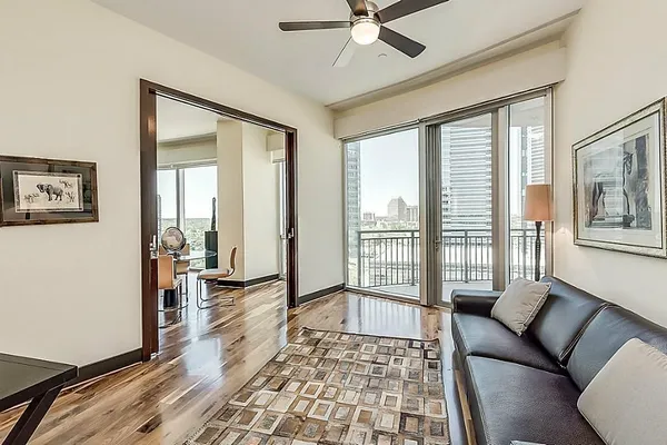 a living room with furniture and a floor to ceiling window