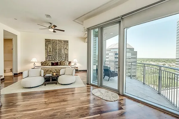 a living room with furniture and a floor to ceiling window