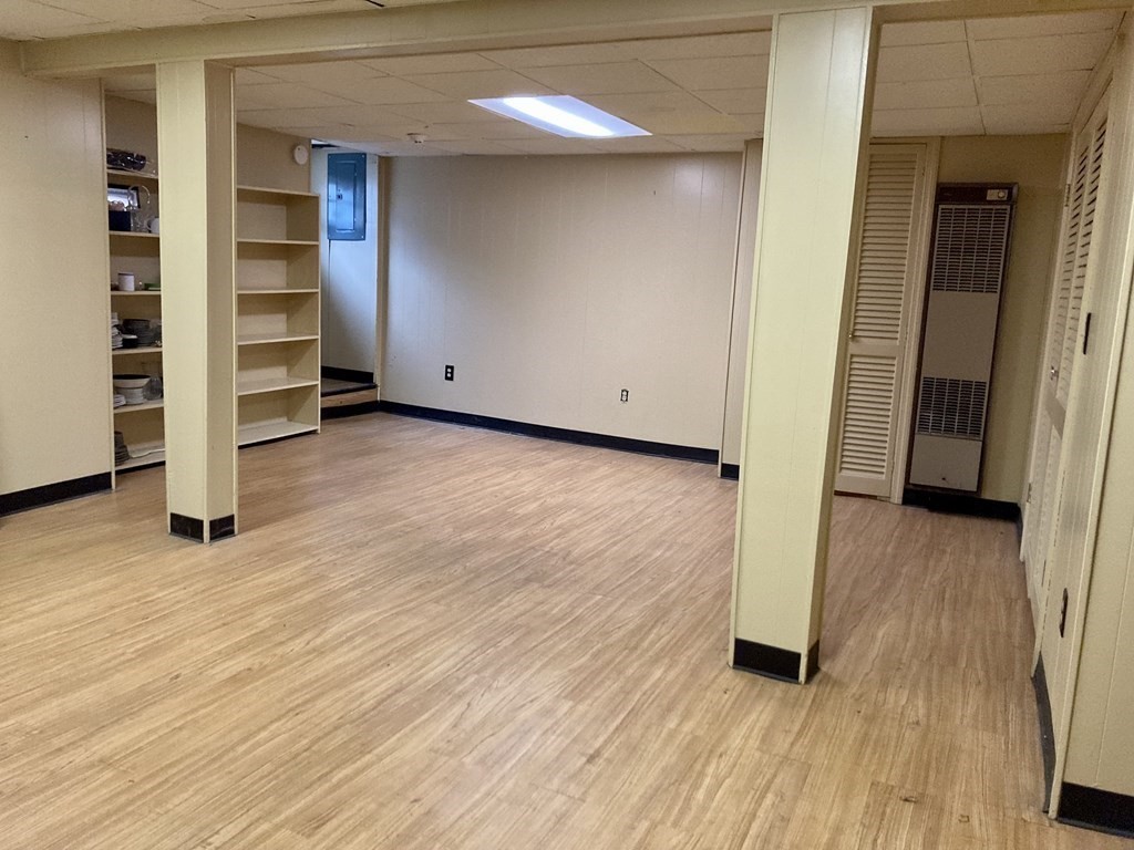 119 Westmoor Road Boston, MA 02132 - Photo 16 of 22 a view of an empty room with a fireplace and wooden floor