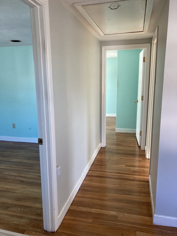 119 Westmoor Road Boston, MA 02132 - Photo 7 of 22 a view of a hallway with wooden floor