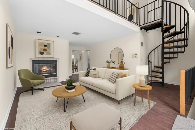 a living room with furniture a rug and a fireplace