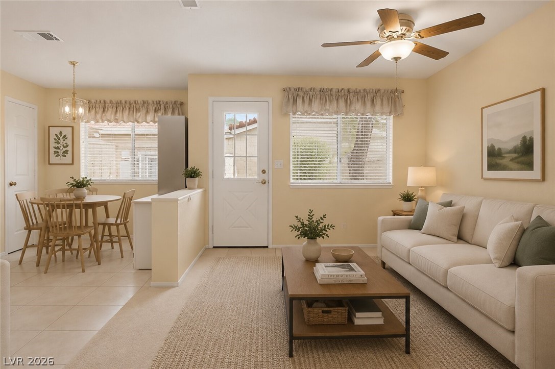2243 Rugged Mesa Drive Laughlin, NV 89029 - Photo 8 of 32 A cheerful open-concept living space features a dining area with a modern chandelier and a comfortable living room with a ceiling fan.