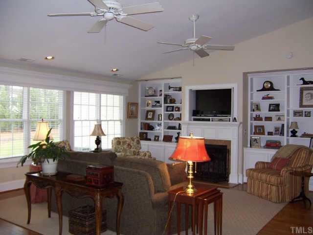 3122 Georgian Terrace Raleigh, NC 27607 - Photo 7 of 12 a living room with furniture a flat screen tv and a fireplace