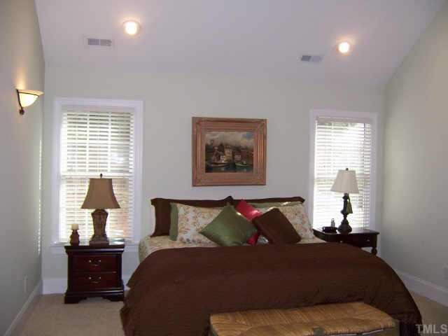 3122 Georgian Terrace Raleigh, NC 27607 - Photo 9 of 12 a bed room with a bed and a lamp