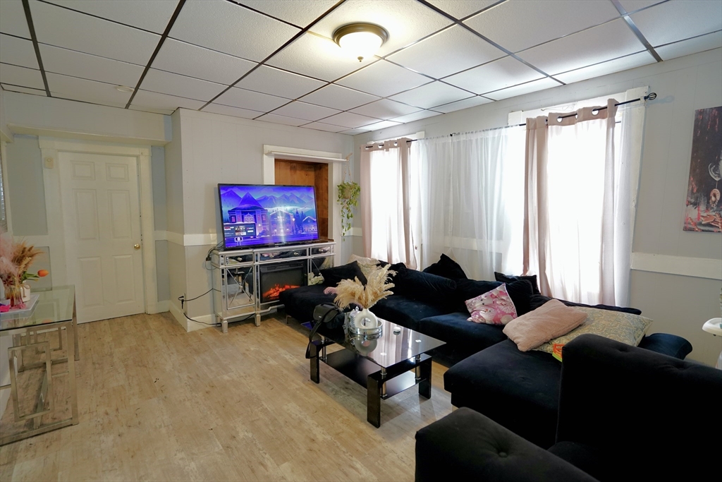 183 Farnham Street Lawrence, MA 01843 - Photo 13 of 38 a living room with furniture a air conditioner vent and a window