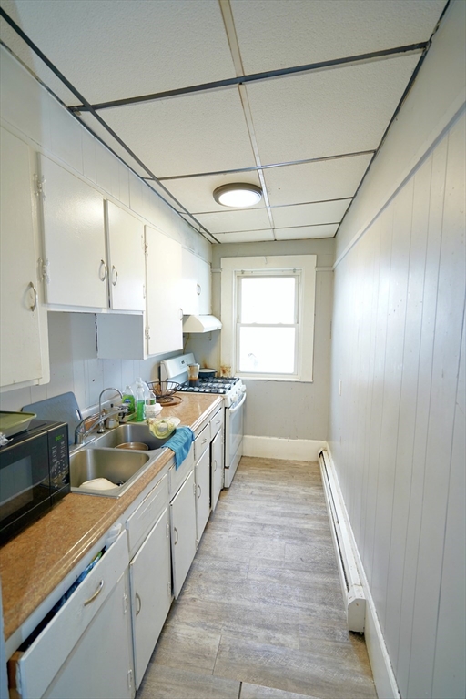 183 Farnham Street Lawrence, MA 01843 - Photo 14 of 38 a large kitchen with stainless steel appliances a large counter top a stove a sink dishwasher and a refrigerator
