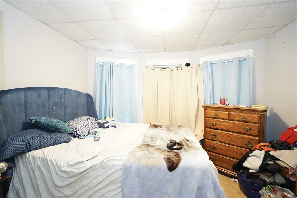 183 Farnham Street Lawrence, MA 01843 - Photo 16 of 38 a bed room with a bed and a chair