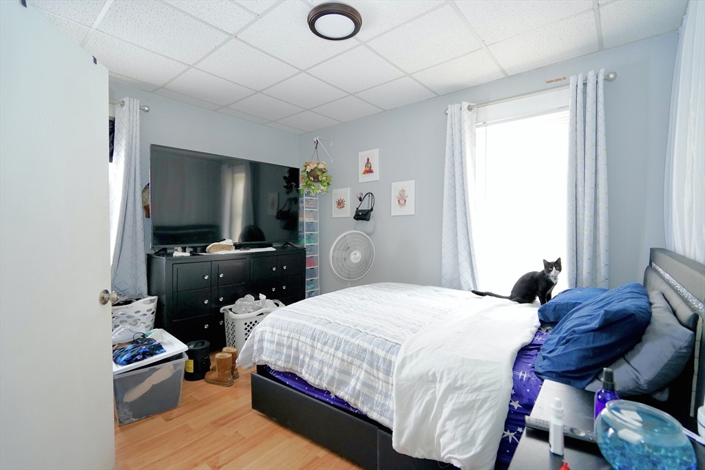 183 Farnham Street Lawrence, MA 01843 - Photo 7 of 38 a bedroom with a bed and wooden floor