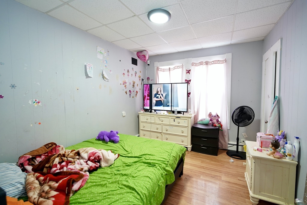 183 Farnham Street Lawrence, MA 01843 - Photo 8 of 38 a bedroom with baby bed and a window