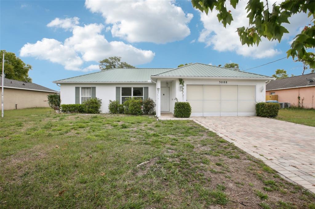 3088 Alex Avenue Spring Hill, FL 34609 - Photo 1 of 1 a front view of a house with garden