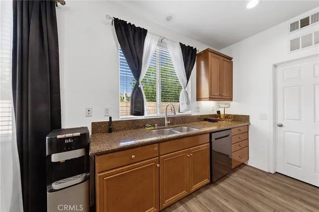 a kitchen with a sink cabinets and window