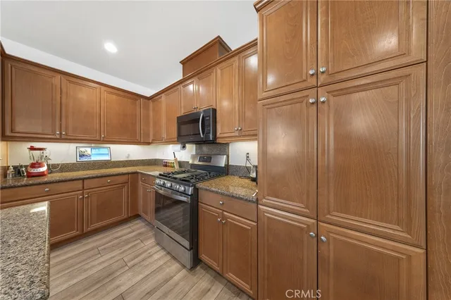 a kitchen with cabinets stainless steel appliances and a sink