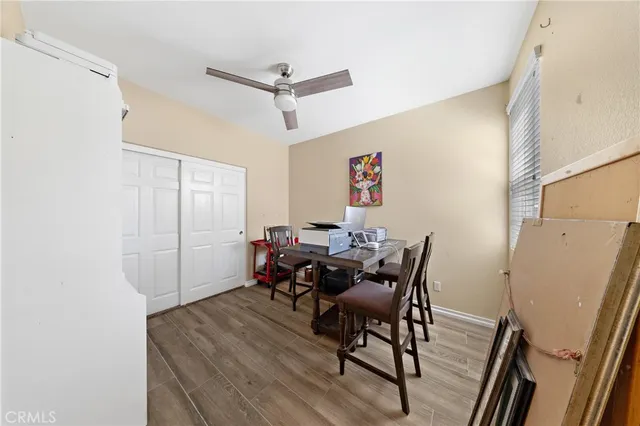 a view of a livingroom with furniture and a ceiling fan