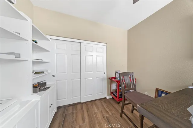 a view of room with guitars and wooden floor