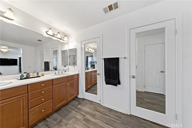 a bathroom with a sink double vanity and mirror