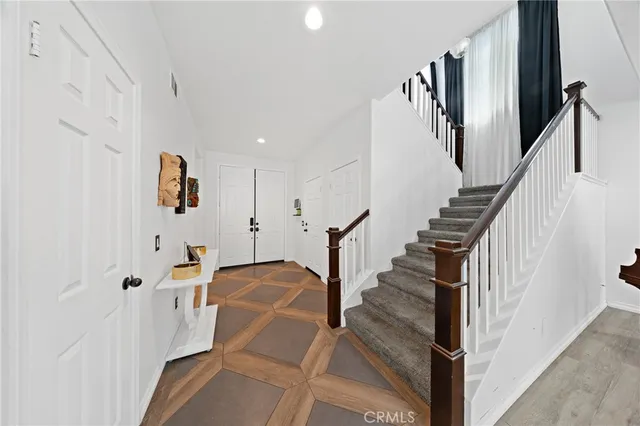 a view of entryway and hall with wooden floor
