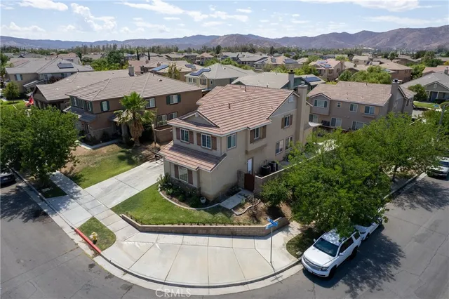 an aerial view of a house with a yard and lake view