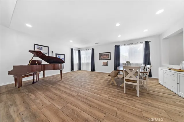 a living room with furniture a wooden floor and a window