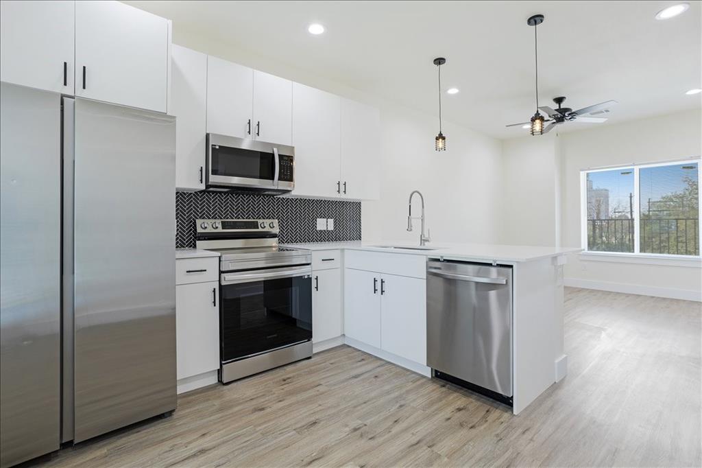 515 South 1st Street, Unit 8 Sherman, TX 75090 - Photo 2 of 7 a kitchen with stainless steel appliances a stove a sink and a refrigerator