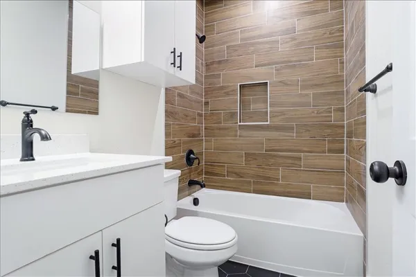 a bathroom with a sink a toilet and bathtub