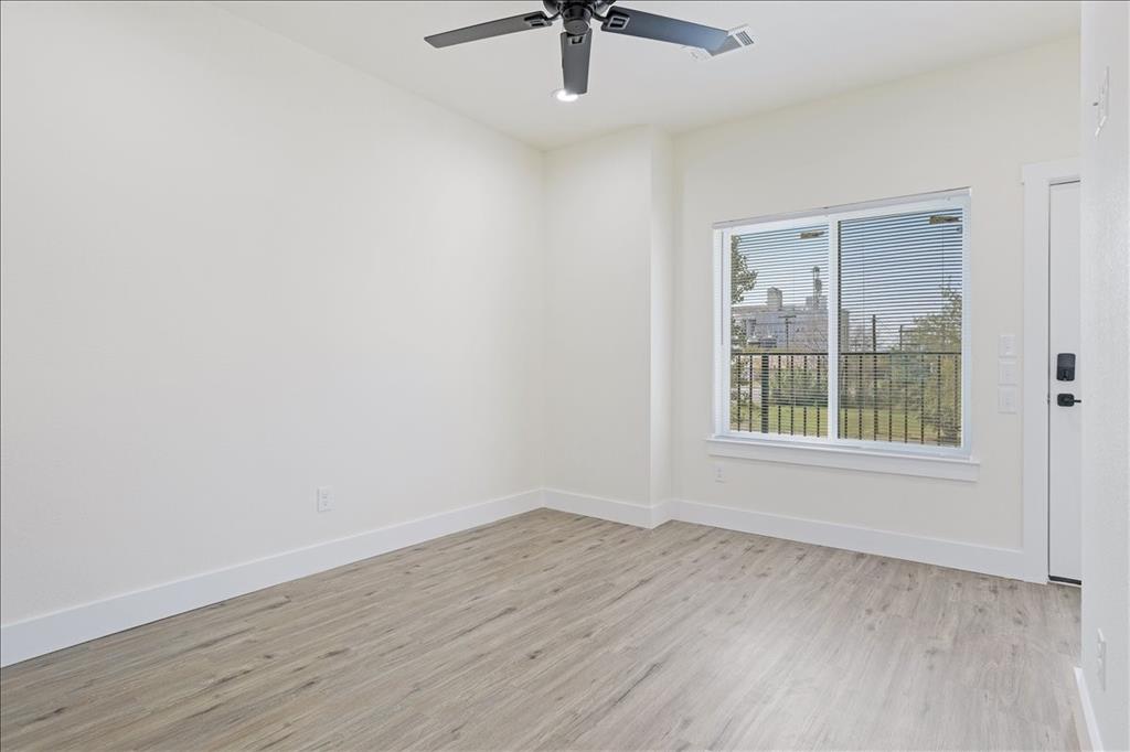 515 South 1st Street, Unit 8 Sherman, TX 75090 - Photo 6 of 7 wooden floor in an empty room with a window