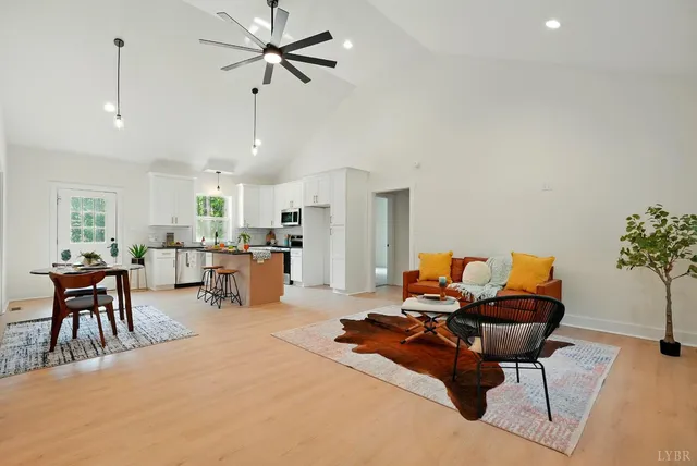 a living room with furniture and kitchen view