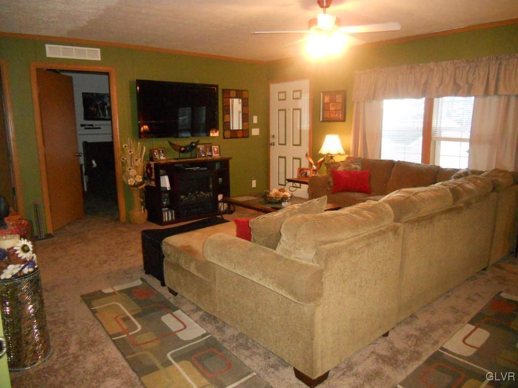 8733 Turkey Ridge Road Breinigsville, PA 18031 - Photo 6 of 19 a living room with furniture and a flat screen tv