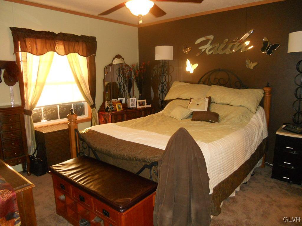8733 Turkey Ridge Road Breinigsville, PA 18031 - Photo 8 of 19 a spacious bedroom with a bed and a chandelier