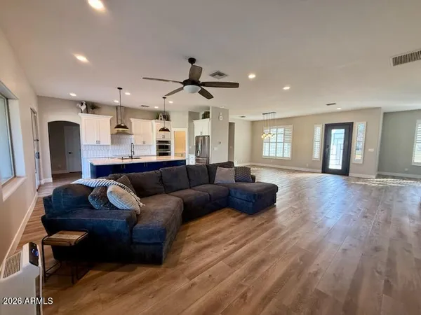 a living room with furniture and a wooden floor