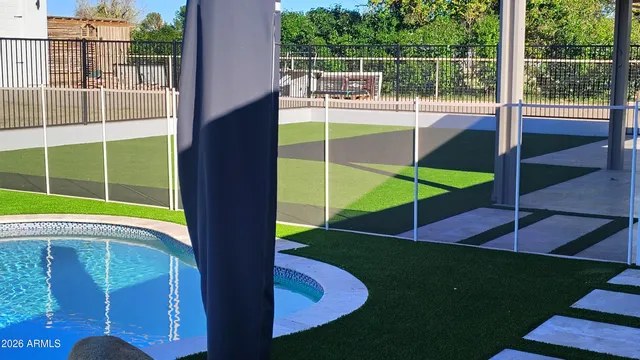 swimming pool view with a garden space